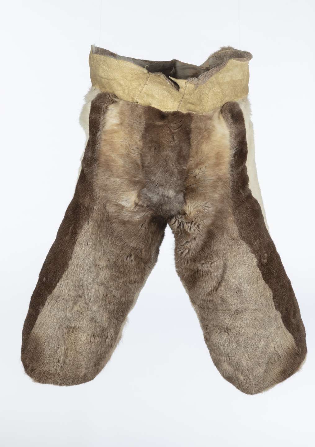 Pantalon en fourrure de caribou, vu de face, brun avec des rayures verticales, brun plus fonc&eacute; et blanc. Le pantalon comporte &eacute;galement une large bande de cuir retourn&eacute; &agrave; la taille.